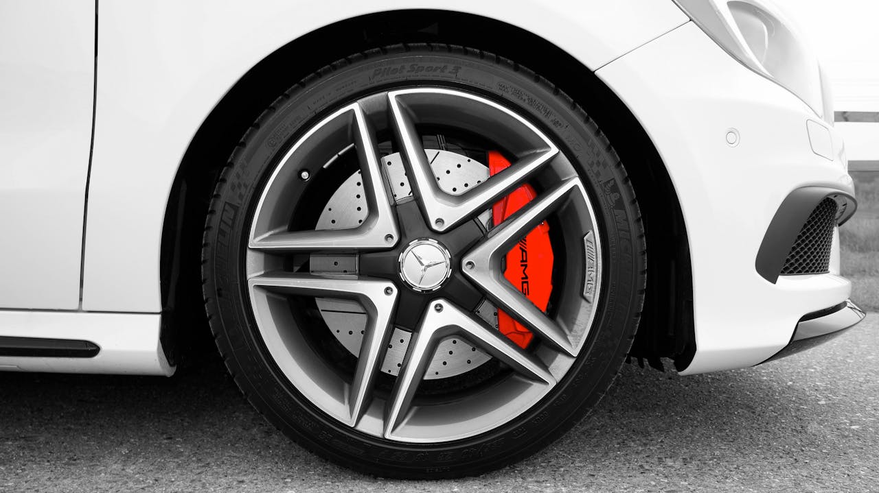 services-03 Detailed shot of a Mercedes-Benz wheel with a red brake caliper, emphasizing luxury and performance.