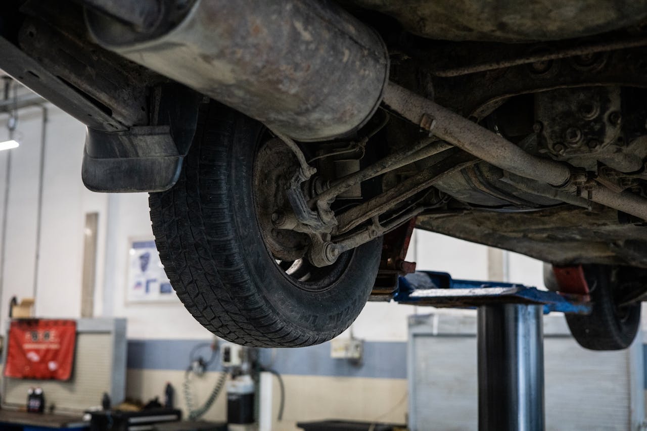get-in-touch Close-up of car's undercarriage in a service station for repair and maintenance.